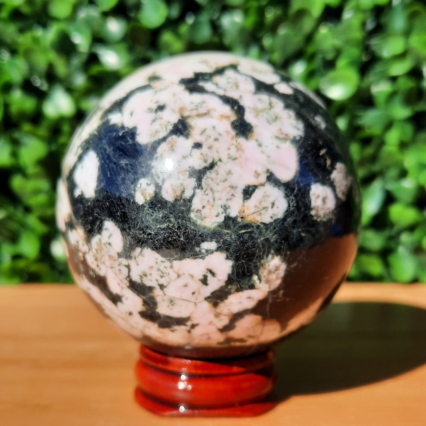 Pink Thulite In Black Jade Sphere